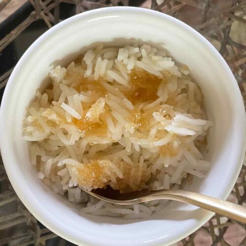 Hot buttered sweet rice in a white bowl.