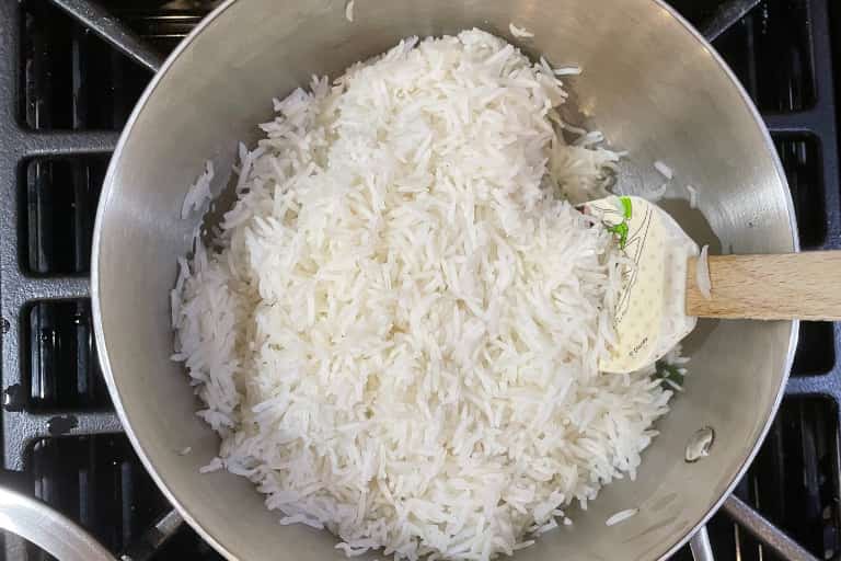 Fluffing cooked basmati rice with silicone spatula.
