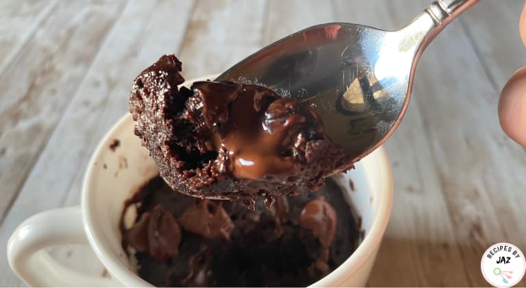 Chocolate mug cake with melted chocolate.